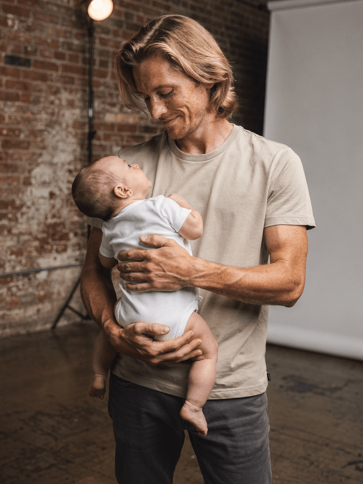 White Tri-Blend Baby Onesie Mockup on Model