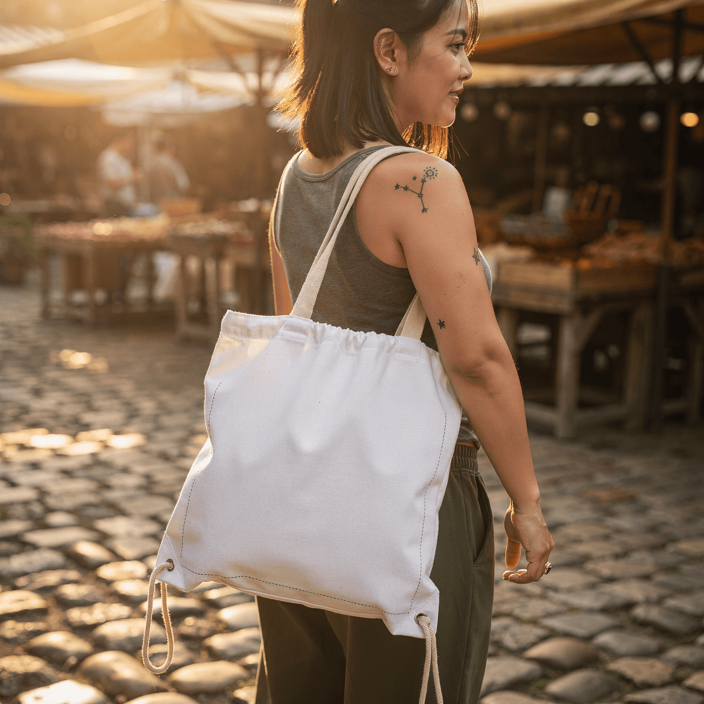 White Cotton Canvas Drawstring Bag Mockup — Three-Quarter Carried View