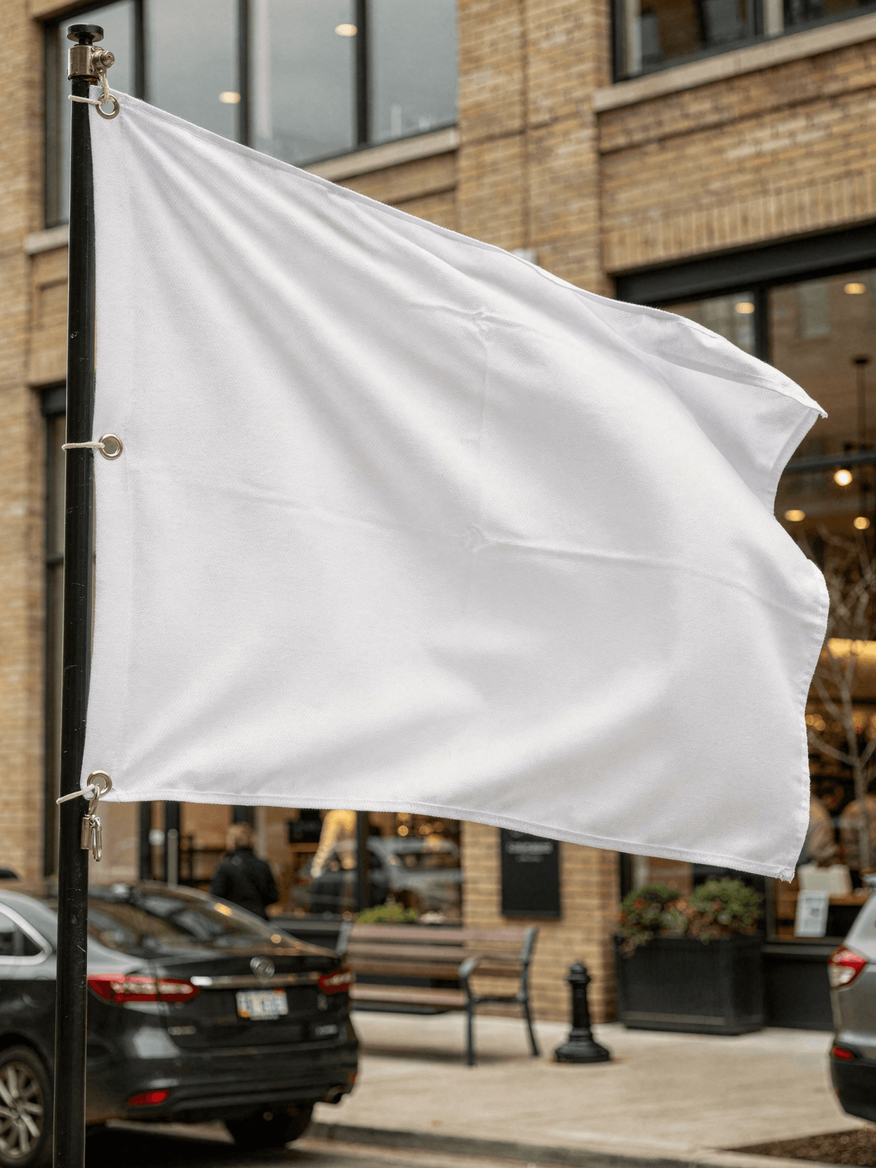 White Flag Mockup - Urban Storefront Pole Mount — Low Angle Pole Mount