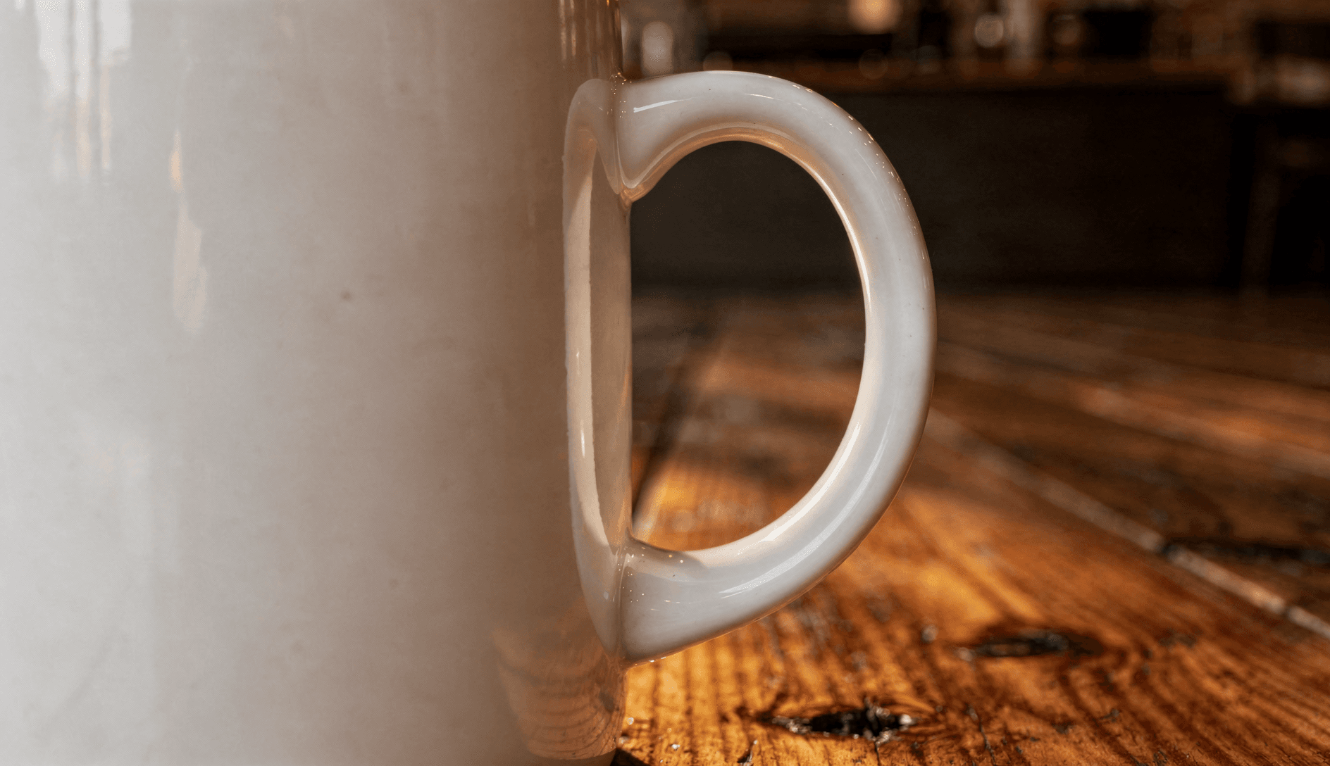 White Ceramic Magic Mug Mockup - Café Setting — Handle Detail Close-Up